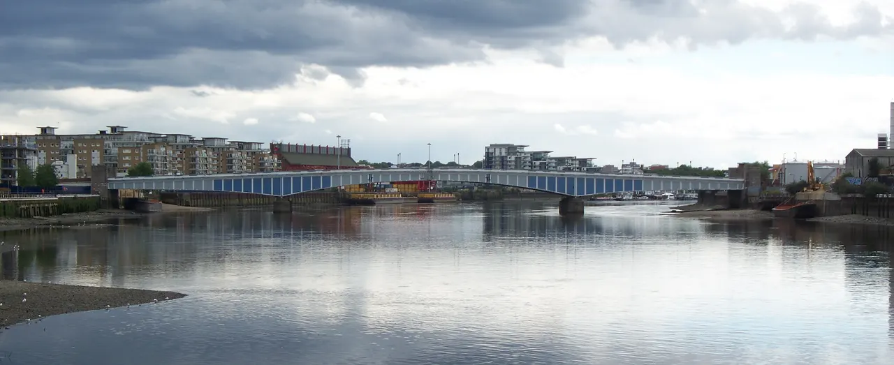 Wandsworth Bridge crossing the Thames under an overcast South London sky